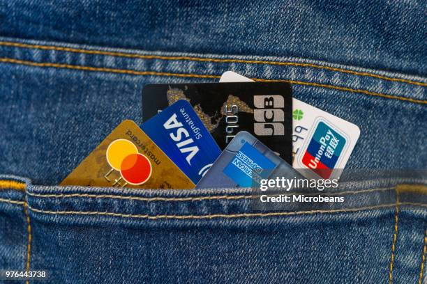 credit cards in jeans pocket - denim suit stock pictures, royalty-free photos & images