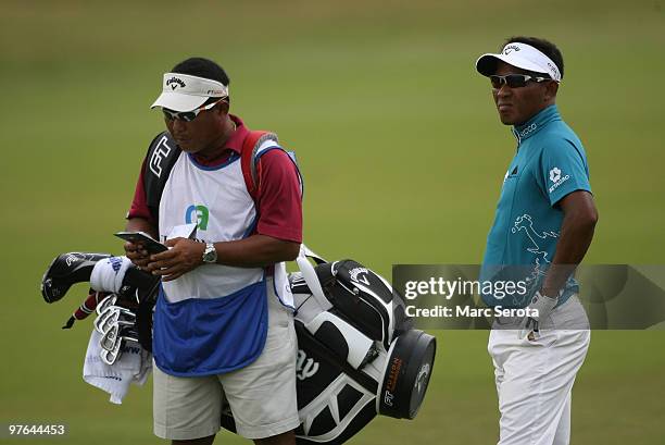 Thongchai Jaidee of Thailand waits to play on the 12th hole during round one of the 2010 WGC-CA Championship at the TPC Blue Monster at Doral on...