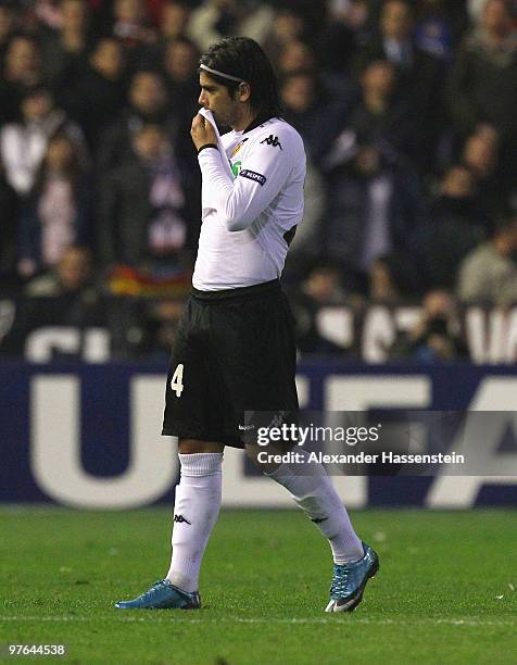 Ever Banega of Valencia leaves the field after receiving the Red card during the UEFA Europa League round of 16 first leg match between Valencia and...