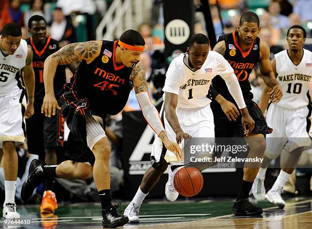 Al-Farouq Aminu of the Wake Forest Demon Deacons and Julian Gamble of the University of Miami Hurricanes chase a loose ball in their first round game...