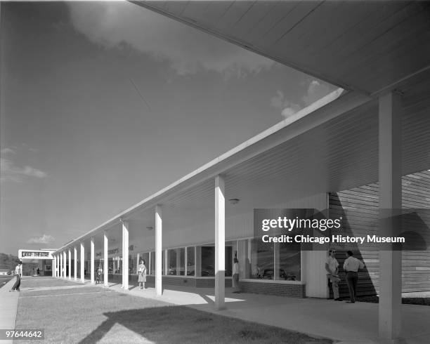 View along an open-air shopping center with a covered walkway in Oak Ridge, Tennessee, July 12, 1944. The city was established in 1942 to house the...
