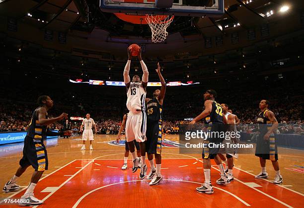 Mouphtaou Yarou of the Villanova Wildcats goes to the hoop against Jimmy Butler of the Marquette Golden Eagles during the quarterfinal of the 2010...