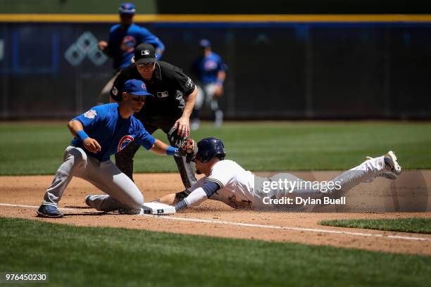 Hernan Perez of the Milwaukee Brewers steals third base past Tommy La Stella of the Chicago Cubs in the second inning at Miller Park on June 13, 2018...