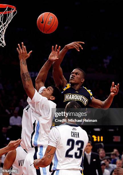 Antonio Pena of the Villanova Wildcats goes to the hoop against Jimmy Butler of the Marquette Golden Eagles during the quarterfinal of the 2010 NCAA...