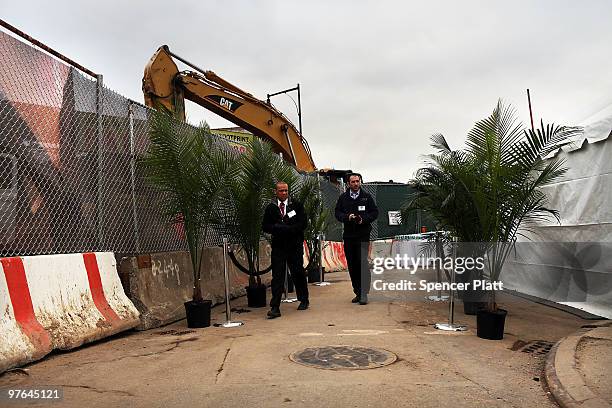 People involved with the ground breaking ceremony of the controversial Atlantic Yards project walk by plants on March 11, 2010 in the Brooklyn...