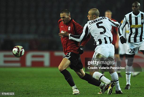 Fabio Cannavaro of Juventus FC battles for the ball with Bobby Zamora of Fulham FC during the UEFA Europa League last 16, first leg match between...