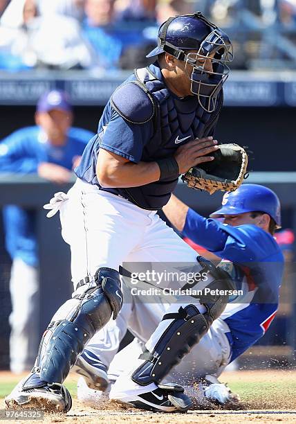 Catcher Yorvit Torrealba of the San Diego Padres catches the ball as Sam Fuld of the Chicago Cubs slides in to score during the second inning of the...