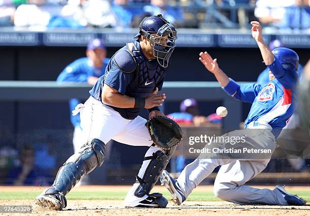 Catcher Yorvit Torrealba of the San Diego Padres catches the ball as Sam Fuld of the Chicago Cubs slides in to score during the second inning of the...