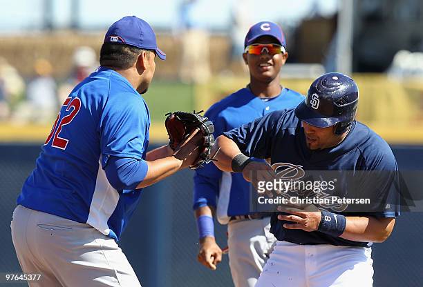 Yorvit Torrealba of the San Diego Padres is taged out in a rundown by pitcher Carlos Silva of the Chicago Cubs during the MLB spring training game at...