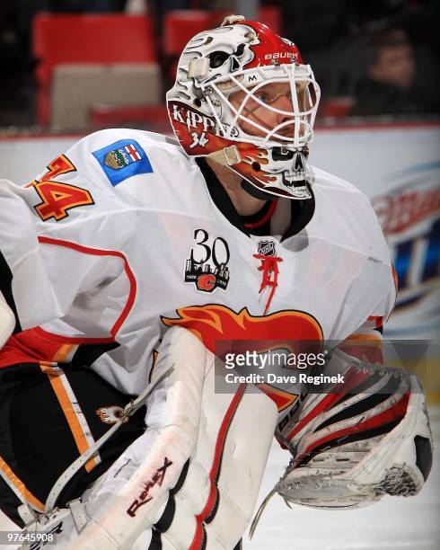 Miikka Kiprusoff of the Calgary Flames focuses on the play during an NHL game against the Detroit Red Wings at Joe Louis Arena on March 9, 2010 in...