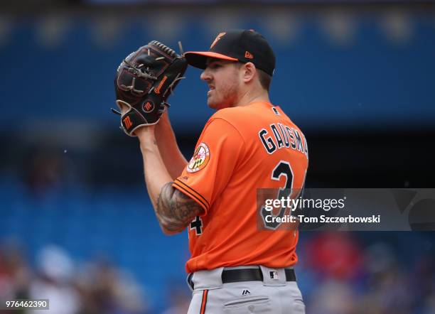 Kevin Gausman of the Baltimore Orioles looks in before delivering a pitch in the fifth inning during MLB game action against the Toronto Blue Jays at...