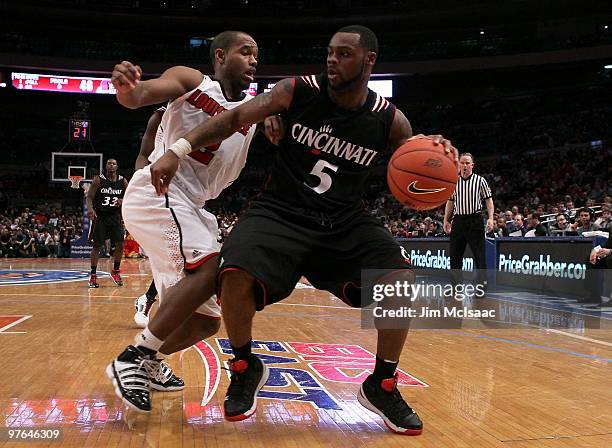 Deonta Vaughn of the Cincinnati Bearcats handles the ball against Preston Knowles of the Louisville Cardinals during the second round of 2010 NCAA...