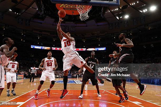 Edgar Sosa of the Louisville Cardinals goes to the hoop against the Cincinnati Bearcats during the second round of 2010 NCAA Big East Tournament at...