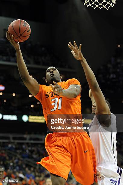 Matt Pilgrim of the Oklahoma State Cowboys goes up for a shot in the lane in the first half against Kansas State Wildcats during the quarterfinals of...