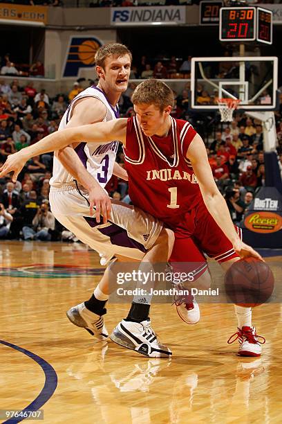 Guard Jordan Hulls of the Indiana Hoosiers drives with the ball against forward Mike Capocci of the Northwestern Wildcats during the first round of...