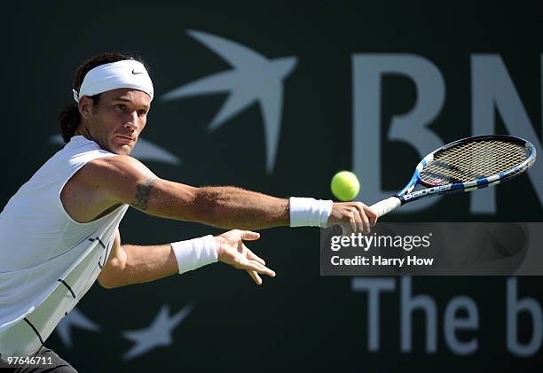 Carlos Moya of Spain reaches for a backhand in his match against Tim Smyczek of the United States during the BNP Paribas Open at the Indian Wells...