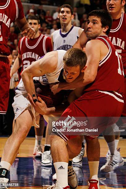Guard Reggie Hearn of the Indiana Hoosiers fights for the ball with forward Mike Capocci of the Northwestern Wildcats during the first round of the...