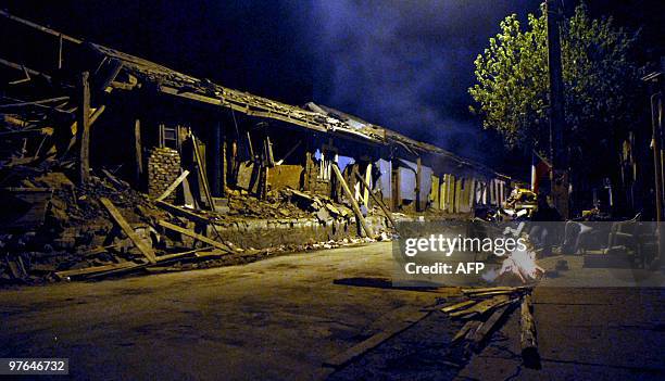Fire burns near a wrecked building in Constitucion, some 350 kms south of Santiago on March 11, 2010. A 6.9-magnitude aftershock and four other...