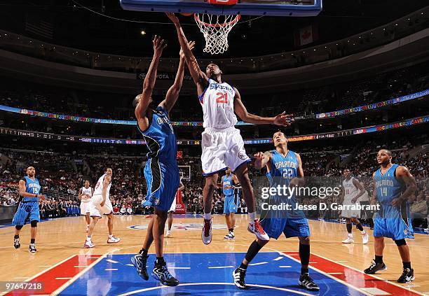 Thaddeus Young of the Philadelphia 76ers shoots a layup against Rashard Lewis and Matt Barnes of the Orlando Magic during the game at Wachovia Center...