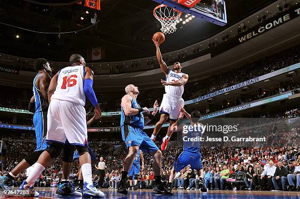 Willie Green of the Philadelphia 76ers shoots a layup over Marcin Gortat and J.J. Redick of the Orlando Magic during the game at Wachovia Center on...