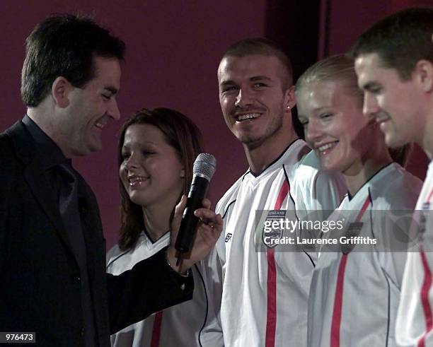 Sky Sports presenter Richard Keys shares a joke with David Beckham of England with reagards to Manchester United's 6-1 win over Arsenal as he lines...