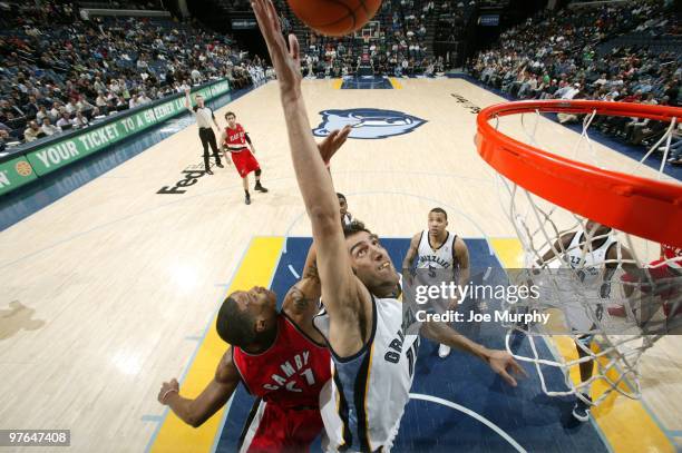 Hamed Haddadi of the Memphis Grizzlies rebounds against Marcus Camby of the Portland Trail Blazers during the game at the FedExForum on March 01,...