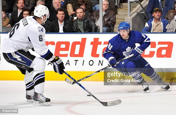 Phil Kessel of the Toronto Maple Leafs skates with the puck as Kurtis Foster of the Tampa Bay Lightning defends during game action March 11, 2010 at...