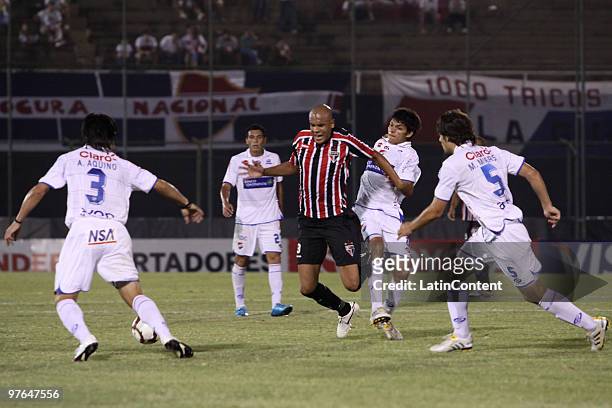 Sao Paulo's Alex Silva vies for the ball with Marcos Riveros , Marcos Miers and Victor Aquino of Paraguayan Nacional during their 2010 Libertadores...
