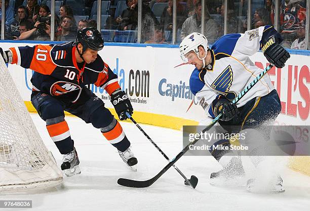 Brad Boyes of the St. Louis Blues and Richard Park of the New York Islanders battle for control of the puck on March 11, 2010 at Nassau Coliseum in...