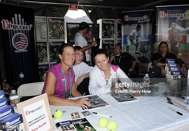 Liezel Huber of the U.S. And Cara Black of Zimbabwe pose with a fan at the Upbucket pavillion during the BNP Paribas Open at the Indian Wells Tennis...