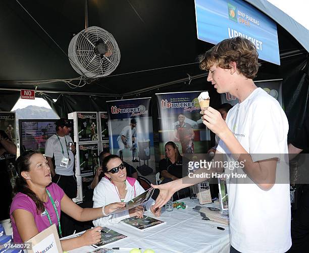Liezel Huber of the U.S. And Cara Black of Zimbabwe sign autographs at the Upbucket pavillion during the BNP Paribas Open at the Indian Wells Tennis...