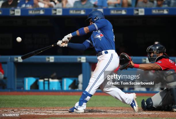 Devon Travis of the Toronto Blue Jays hits a two-run home run in the fifth inning during MLB game action against the Washington Nationals at Rogers...