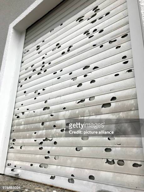 June 2018, Germany, Furth im Wald: Roller shutters damaged by by hail seen after a storm. Heavy storms were rading on Monday afternoon and during the...