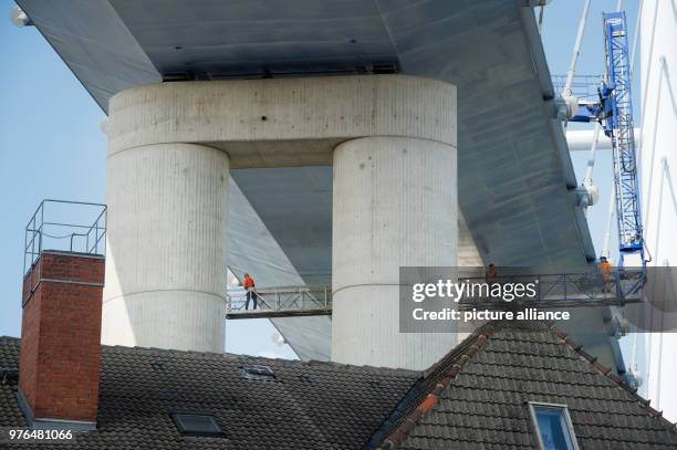 June 2018, Germany, Stralsund: Engineers check the Ruegen Bridge with a lifting platform. Temporarily, one direction of the 2,8-kilometres-long...