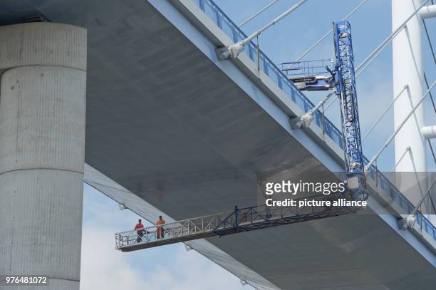 June 2018, Germany, Stralsund: Engineers check the Ruegen Bridge with a lifting platform. Temporarily, one direction of the 2,8-kilometres-long...