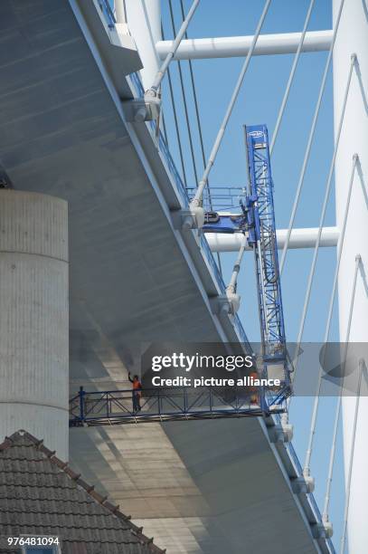 June 2018, Germany, Stralsund: Engineers check the Ruegen Bridge with a lifting platform. Temporarily, one direction of the 2,8-kilometres-long...