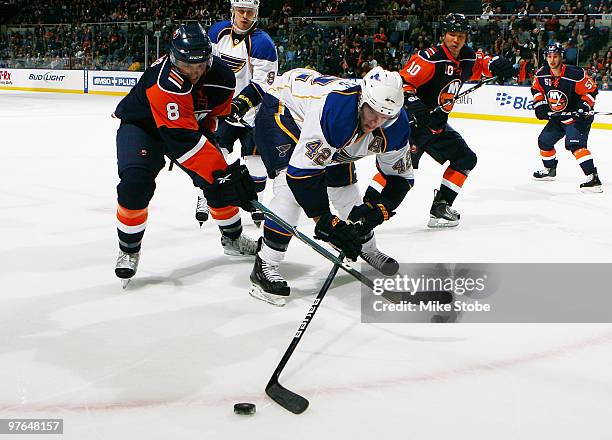 Bruno Gervais of the New York Islanders stick checks David Backes of the St. Louis Blues on March 11, 2010 at Nassau Coliseum in Uniondale, New York.