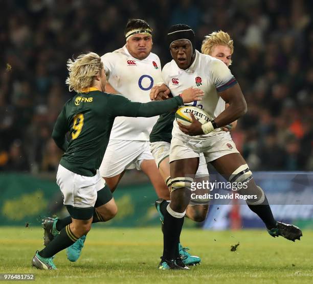 Maro Itoje of England is held by Faf de Klerk during the second test match between South Africa and England at Toyota Stadium on June 16, 2018 in...
