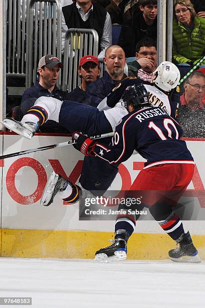 Kris Russell of the Columbus Blue Jackets finishes a check on Colby Armstrong of the Atlanta Thrashers during the second period on March 11, 2010 at...