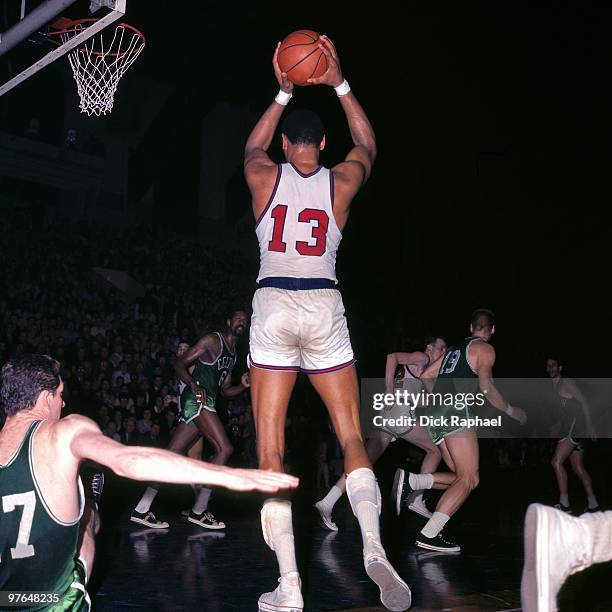 Wilt Chamberlain of the Philadelphia 76ers rebounds against the Boston Celtics during a game played in 1967 at the Boston Garden in Boston,...