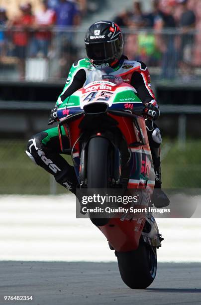 Scott Redding of Great Britain and Aprilia Racing Team Gresini lifts the front wheel during free practice for the MotoGP of Catalunya at Circuit de...