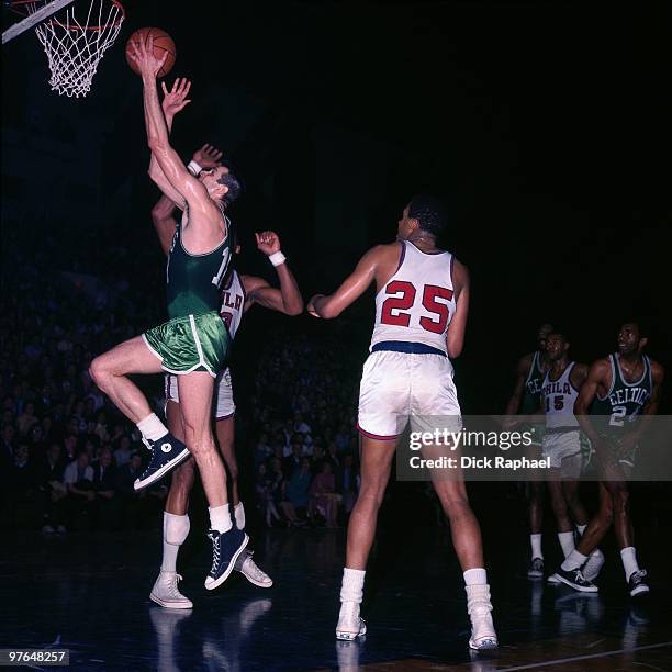 Jim Barnett of the Boston Celtics shoots a layup against the Philadelphia 76ers during a game played in 1967 at the Boston Garden in Boston,...