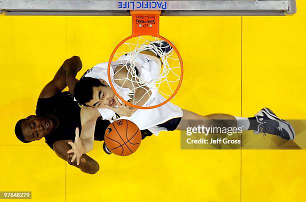 Jeremy Jacob of the Oregon ducks and Max Zhang of the Cal Golden Bears battle for a rebound during the Quarterfinals of the Pac-10 Basketball...