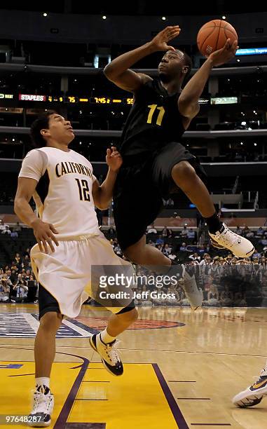 Malcolm Armstead of the Oregon ducks shoots over Brandon Smith of the Cal Golden Bears in the second half during the Quarterfinals of the Pac-10...