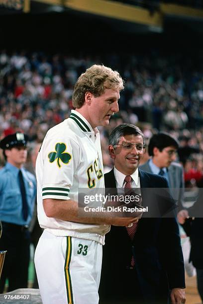 Commissioner David Stern presents Larry Bird of the Boston Celtics with his ring during the 1984 NBA Championship Ring Ceremony prior to a game...