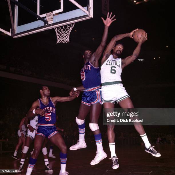 Bill Russell of the Boston Celtics rebounds against Bob Warlick of the Detroit Pistons during a game played in 1967 at the Boston Garden in Boston,...