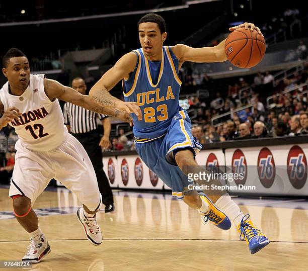 Tyler Honeycutt of the UCLA Bruins drives around Lamont Jones of the Arizona Wildcats during the quarterfinals of the Pac-10 Basketball Tournament at...