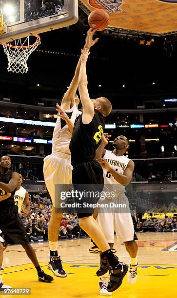 Max Zhang of the California Golden Bears blocks a shot by E.J. Singler of the Oregon Ducks during the quarterfinals of the Pac-10 Basketball...