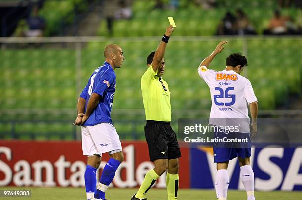Kleber Freitas of Brazil's Cruzeiro receives yellow card durig a match against Venezuela's Deportivo Italia as part of the Libertadores Cup 2010 on...