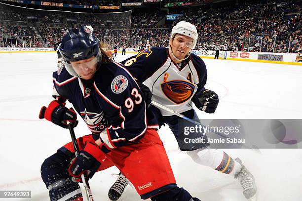 Jakub Voracek of the Columbus Blue Jackets and Ron Hainsey of the Atlanta Thrashers battle in the corner during the third period on March 11, 2010 at...